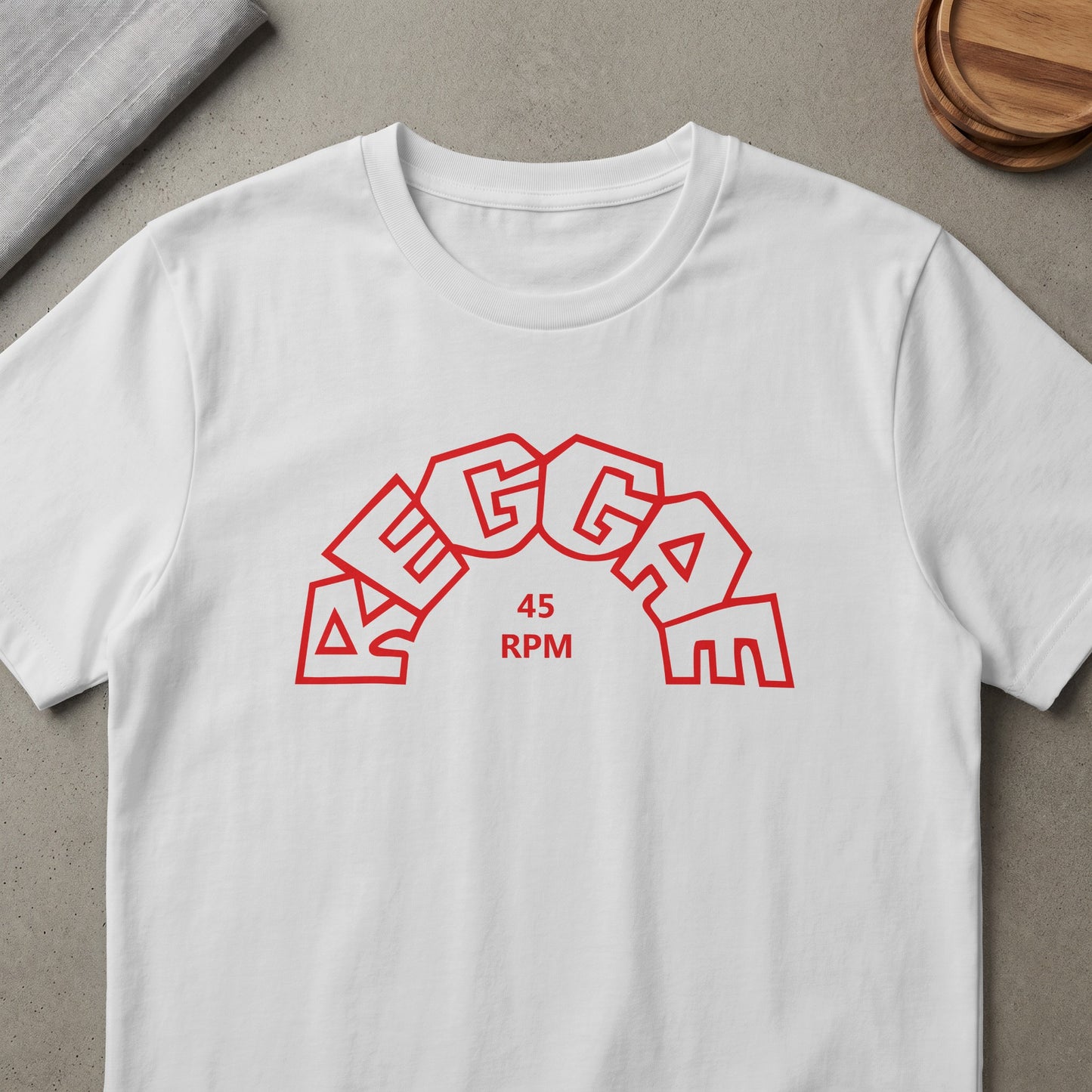 White t-shirt with red text "REGGAE 45 RPM" in a curved design.