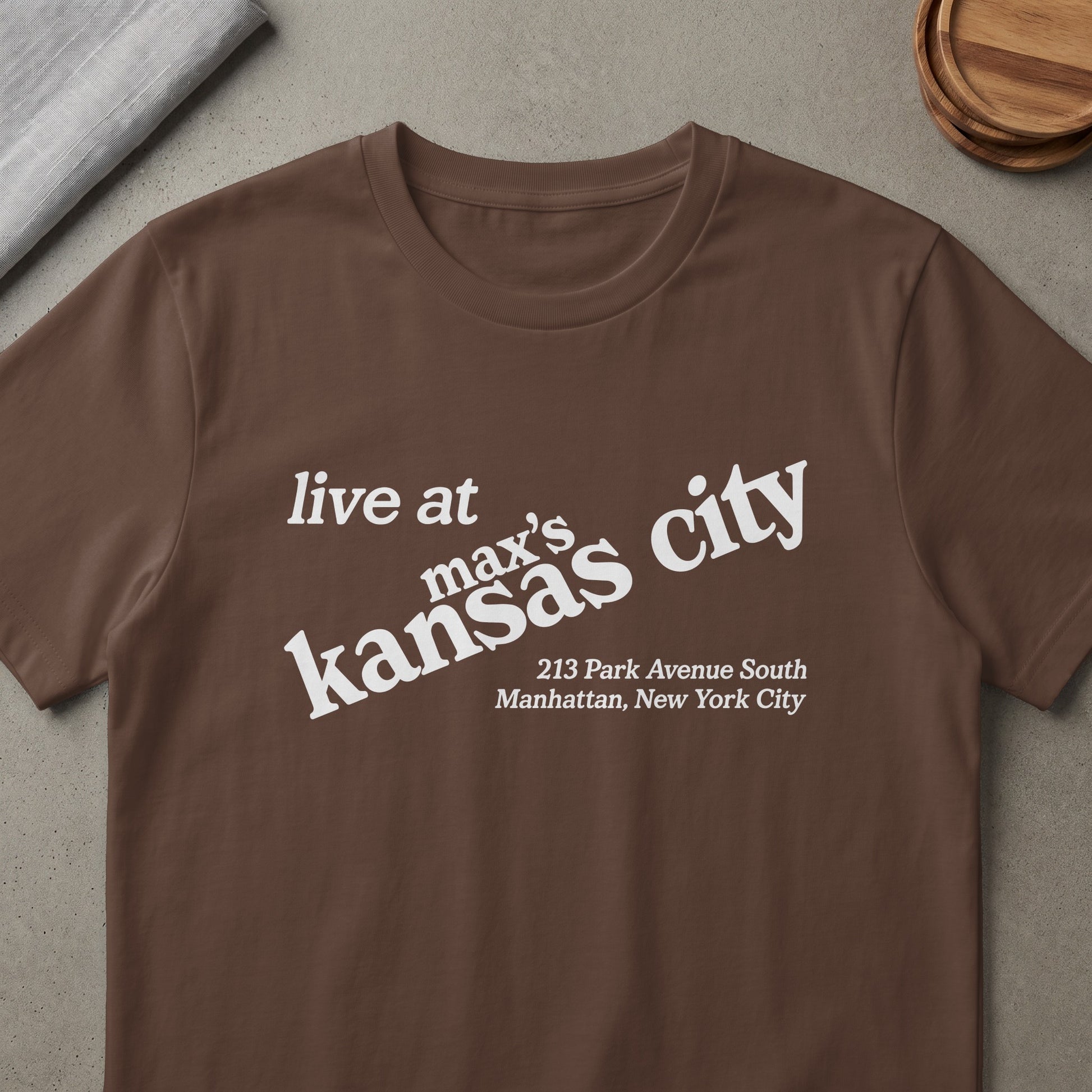 Brown t-shirt with white text "live at max's kansas city" and address.