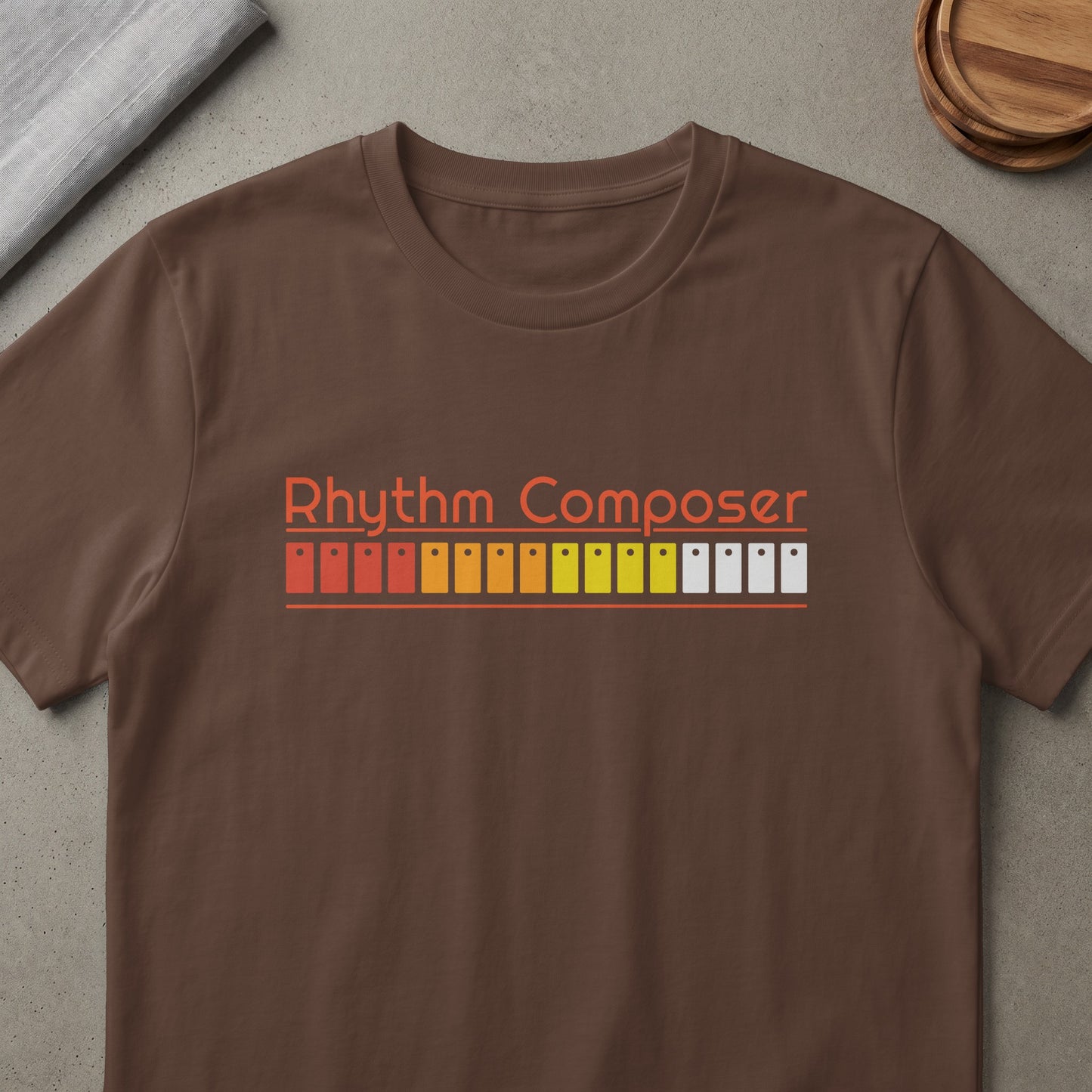 Brown t-shirt with "Rhythm Composer" text and graphic of drum machine pads.