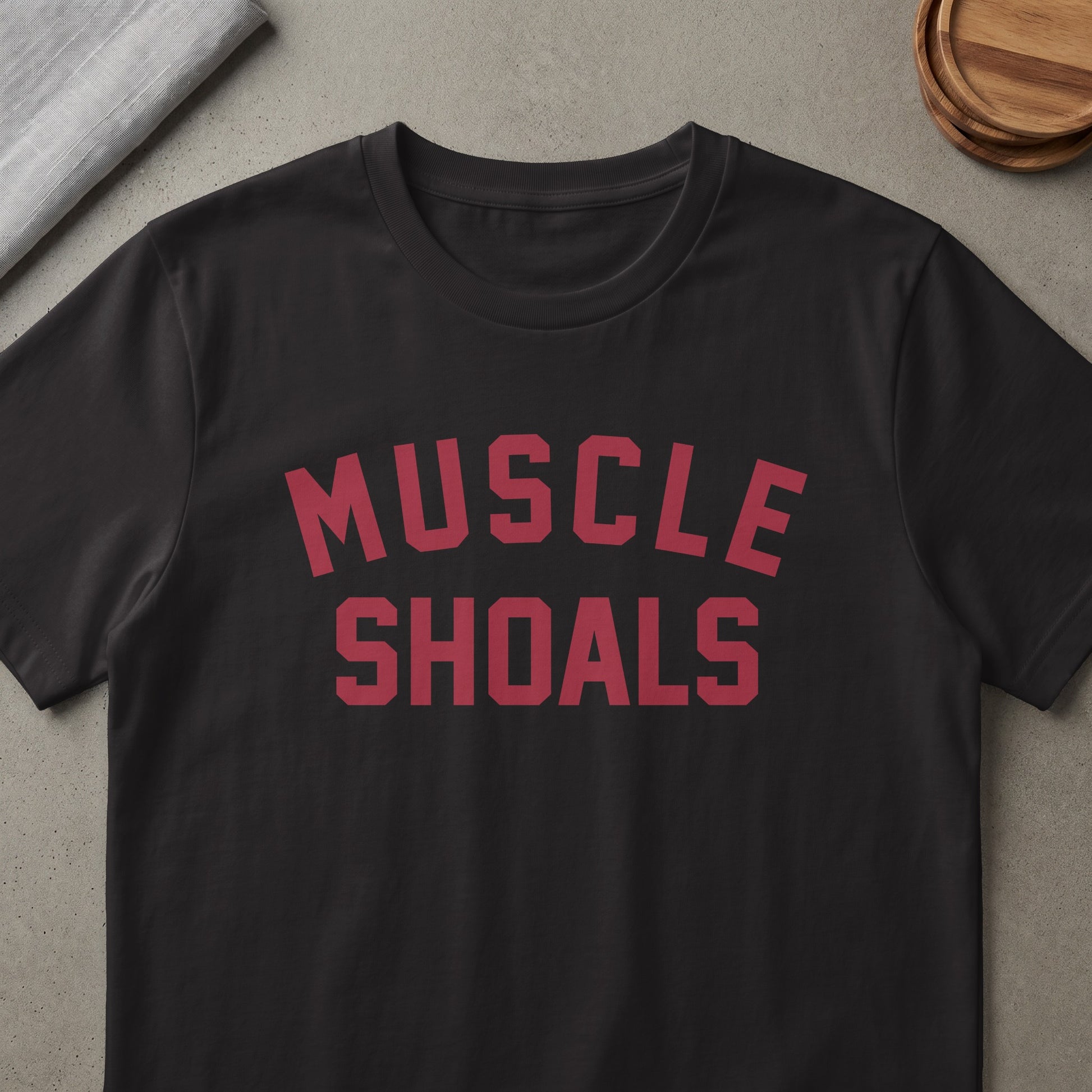 Black t-shirt with red text "MUSCLE SHOALS".