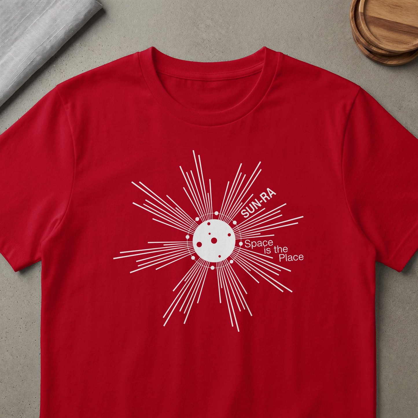 Red t-shirt with white Sun-Ra "Space is the Place" graphic featuring a sunburst and moon.