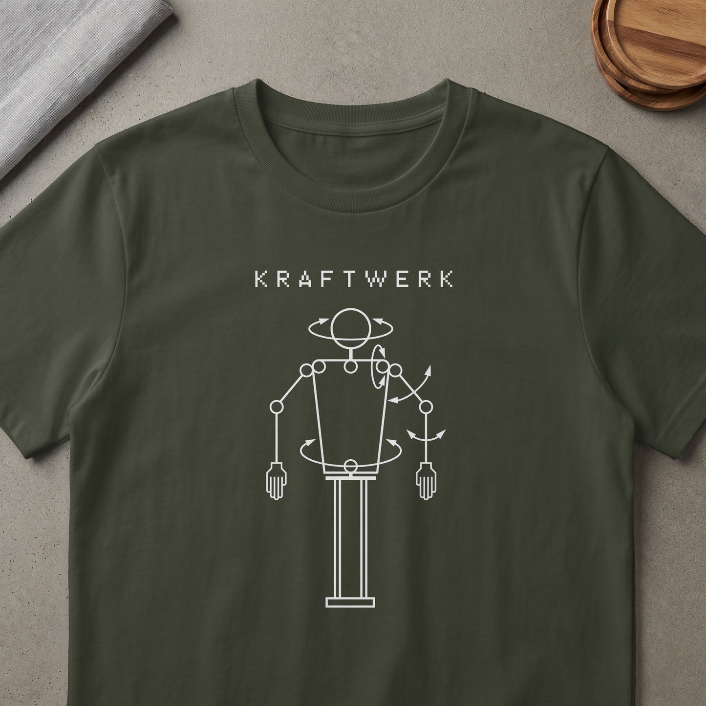 Kraftwerk logo and robotic diagram on a dark green t-shirt.