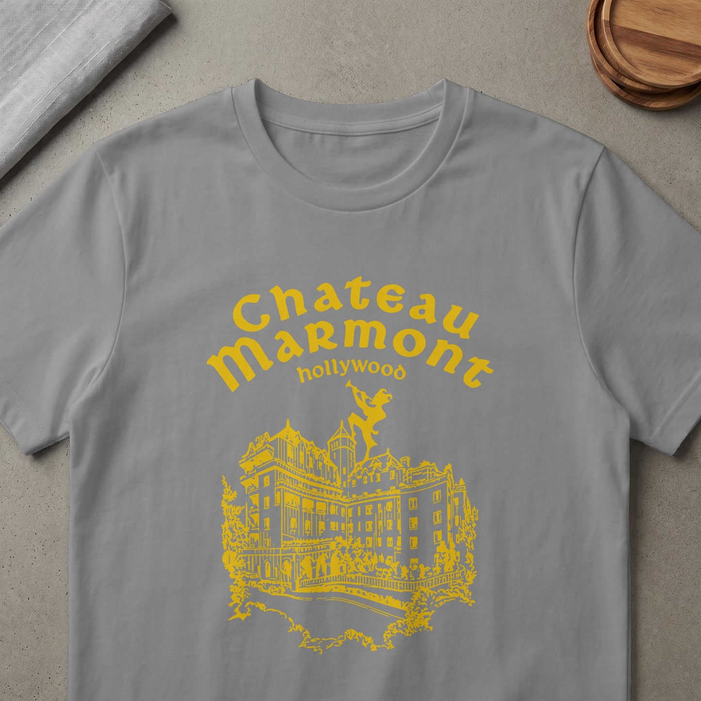 Grey t-shirt with yellow Chateau Marmont Hollywood logo and building illustration.