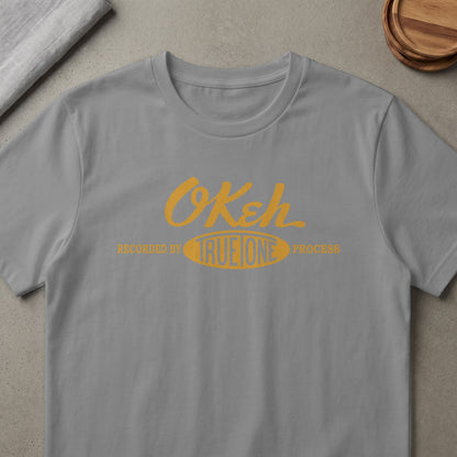 Grey t-shirt with yellow "OKeh" logo and text "RECORDED BY TRUEONE PROCESS"