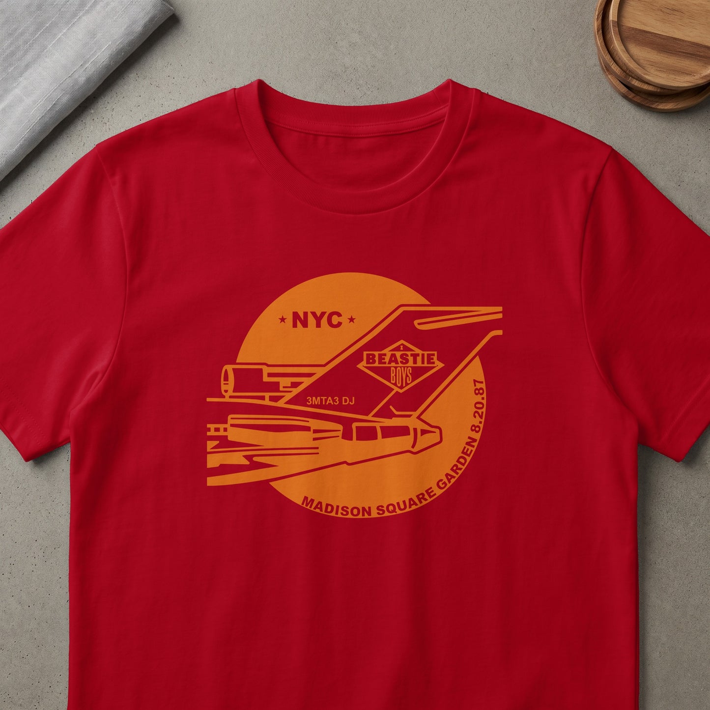Red t-shirt with Beastie Boys graphic featuring NYC, 3mta3 DJ, and Madison Square Garden 8.20.87.