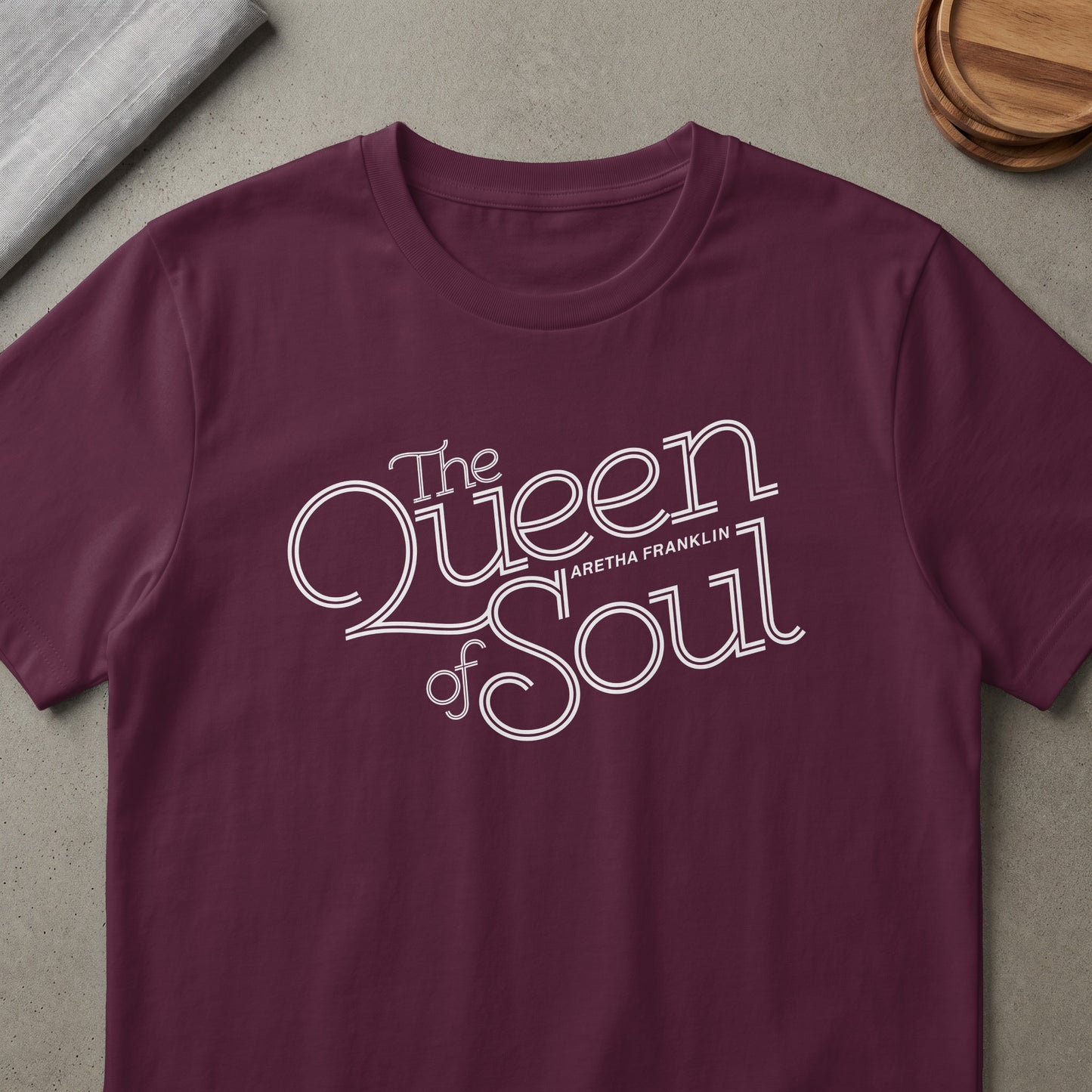 Burgundy t-shirt with "The Queen of Soul Aretha Franklin" in white stylized text.