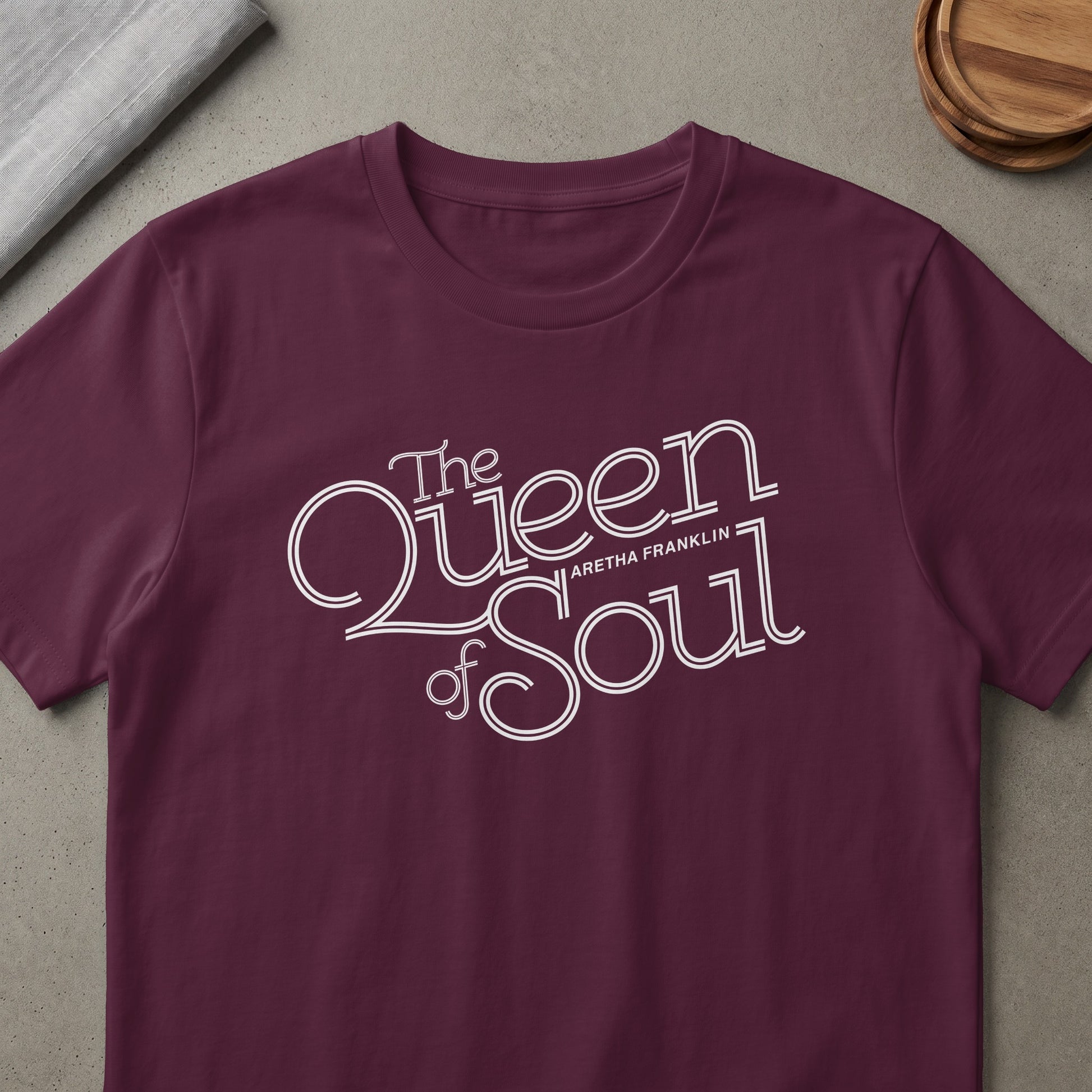 Burgundy t-shirt with "The Queen of Soul Aretha Franklin" in white stylized text.