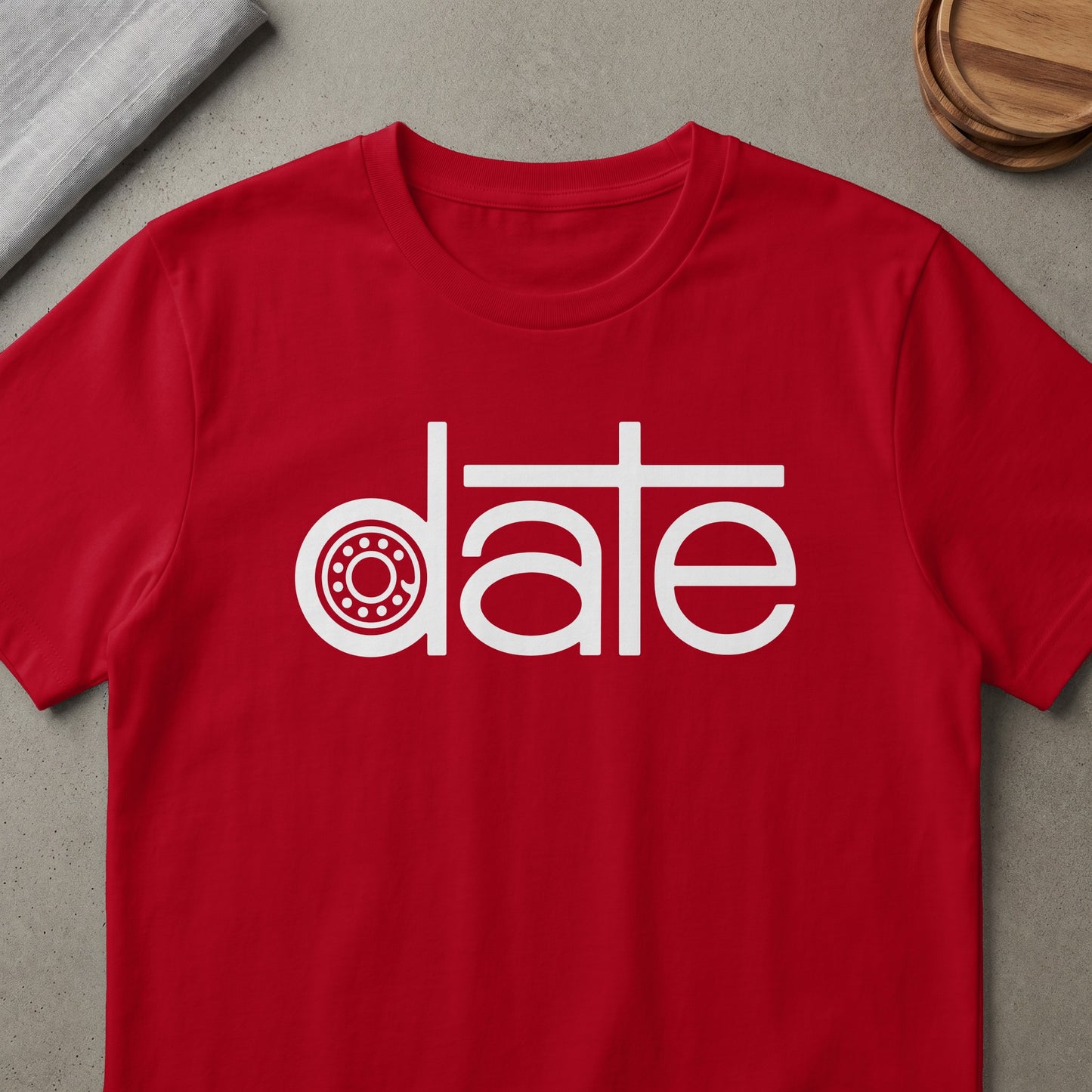 Red t-shirt with white text graphic featuring a stylized "date" with a gear.