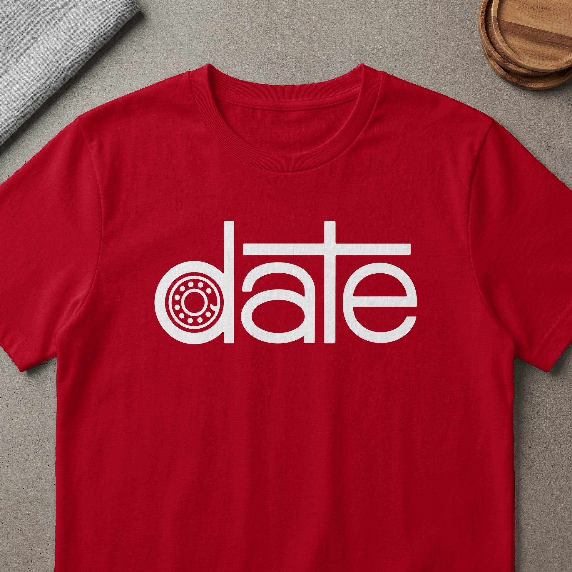 Red t-shirt with white text graphic featuring a stylized "date" with a gear.
