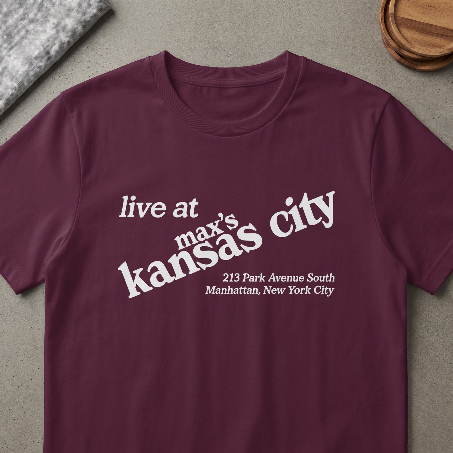 Maroon t-shirt with white text "live at max's kansas city 213 Park Avenue South Manhattan, New York City".