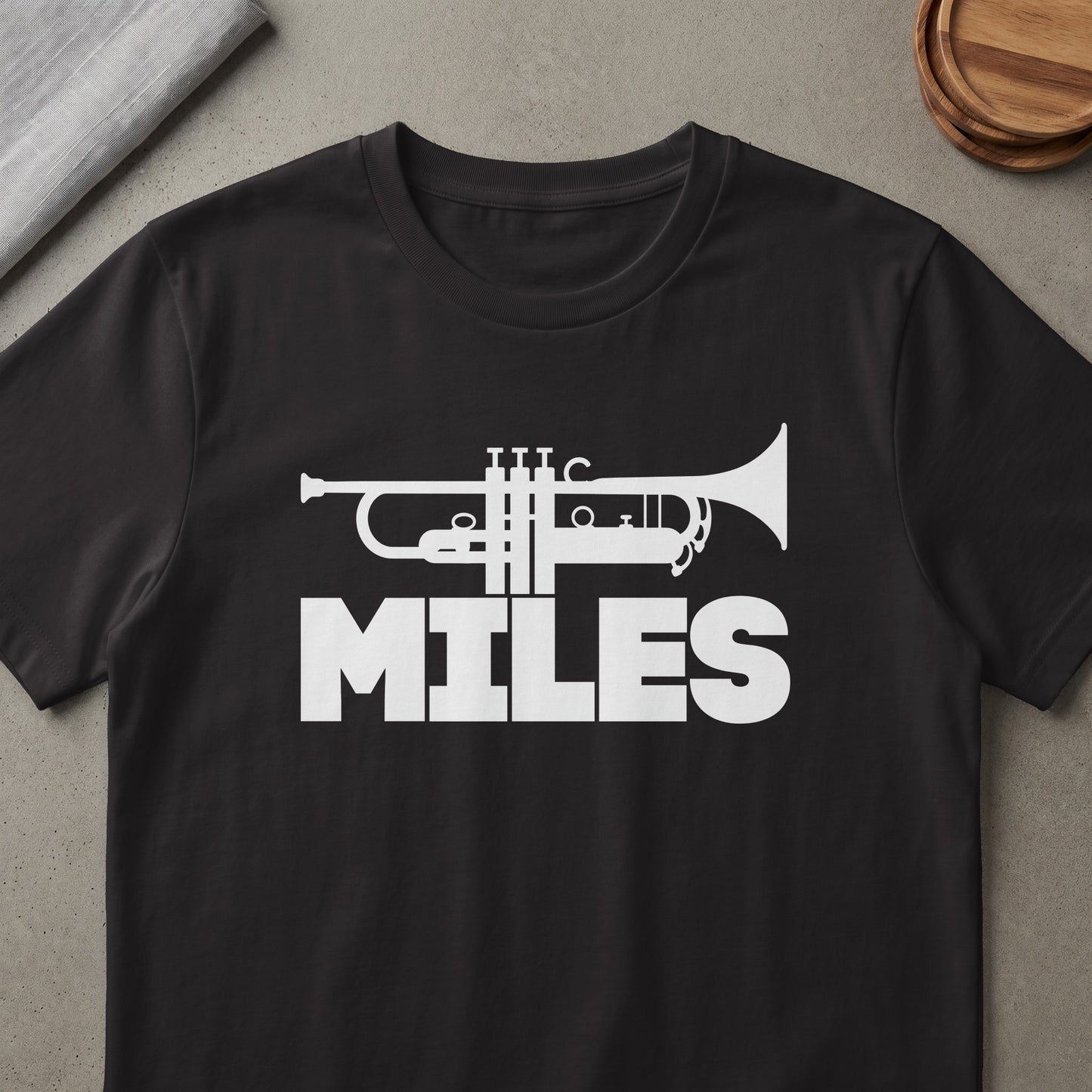 Black t-shirt with white trumpet graphic and "MILES" text.