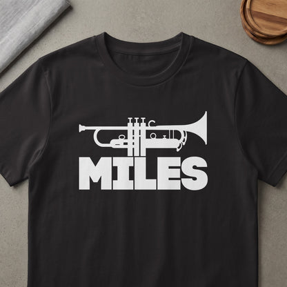 Black t-shirt with white trumpet graphic and "MILES" text.
