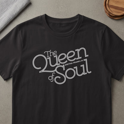 Black t-shirt with "The Queen of Soul Aretha Franklin" white text graphic.