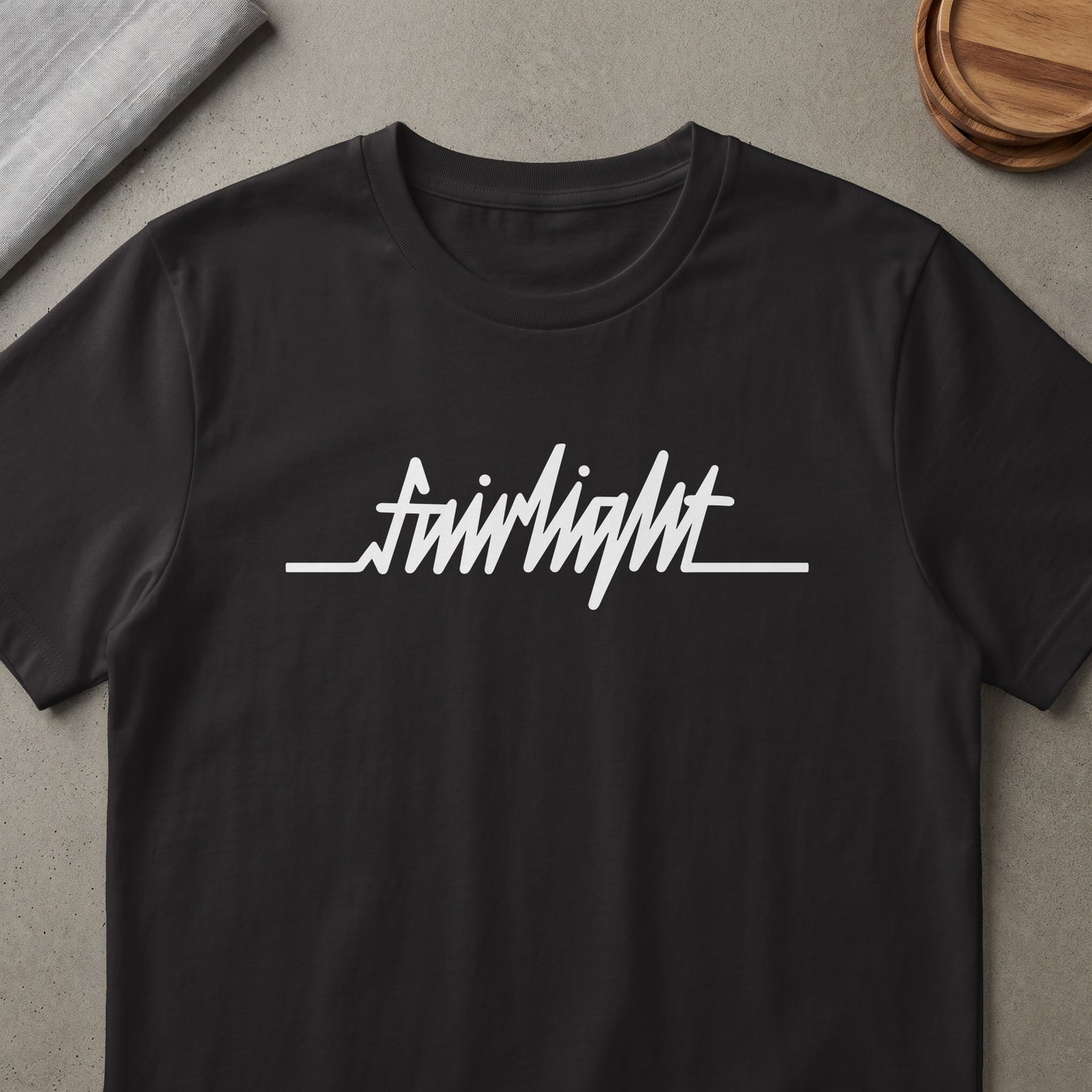 Black t-shirt with white "fairlight" text logo that resembles a heartbeat.