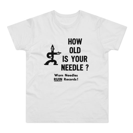 White t-shirt with black text "HOW OLD IS YOUR NEEDLE?" and an illustration of a record player needle.