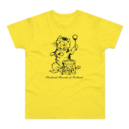 Yellow t-shirt with black ink drawing of a cat playing a drum, reads "Postcard Records of Scotland".