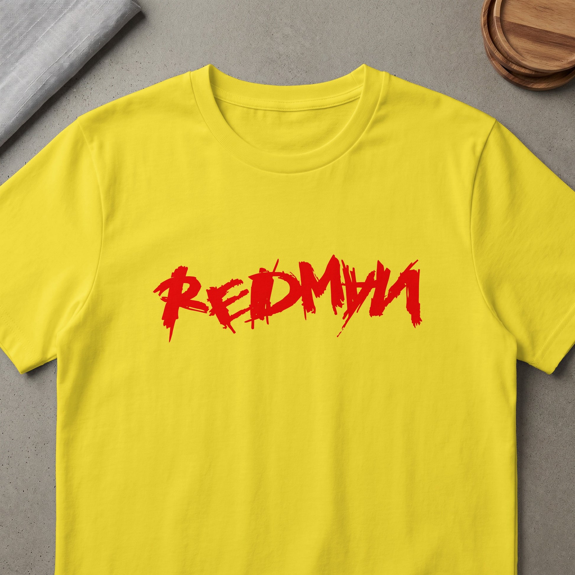 Yellow t-shirt with distressed red "REDMYN" graphic print.