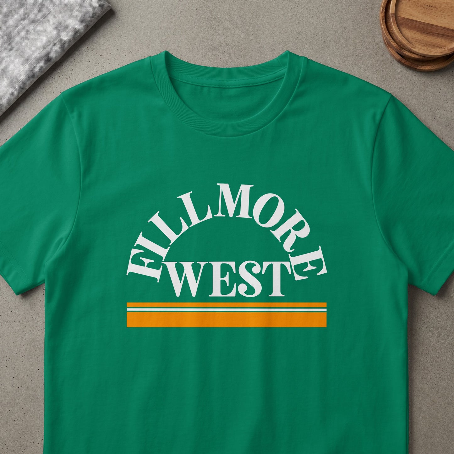 Green t-shirt with "Fillmore West" text and horizontal stripes.