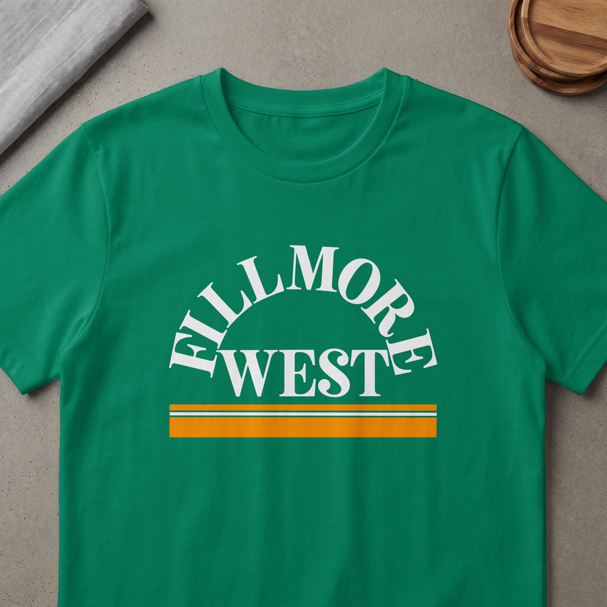Green t-shirt with "Fillmore West" text and horizontal stripes.