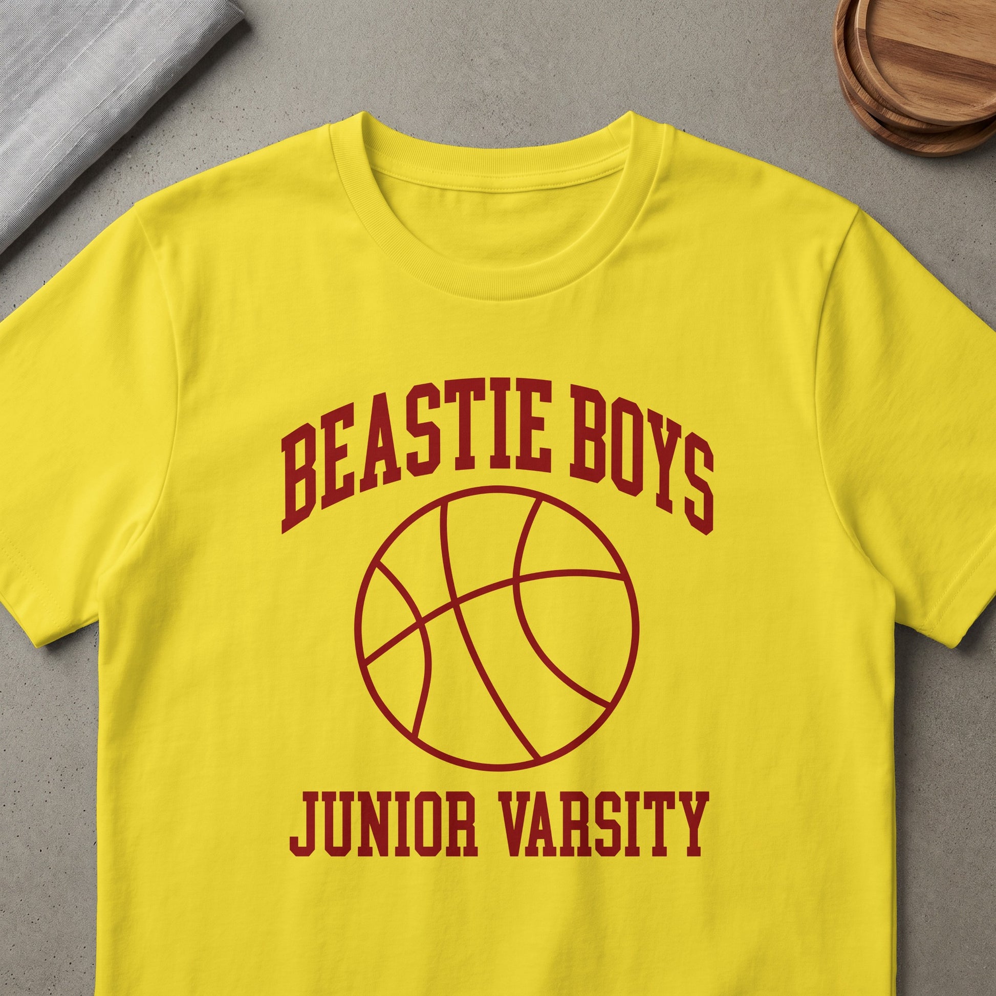 Yellow t-shirt with maroon "Beastie Boys Junior Varsity" text and basketball graphic.