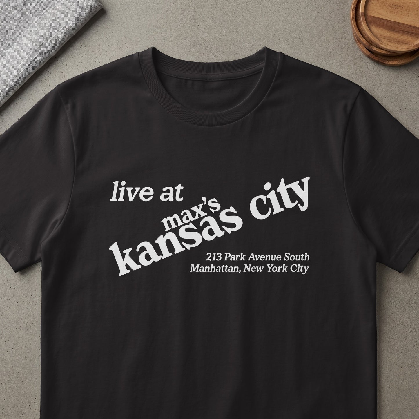 Black t-shirt with white text: "live at max's kansas city 213 Park Avenue South Manhattan, New York City"