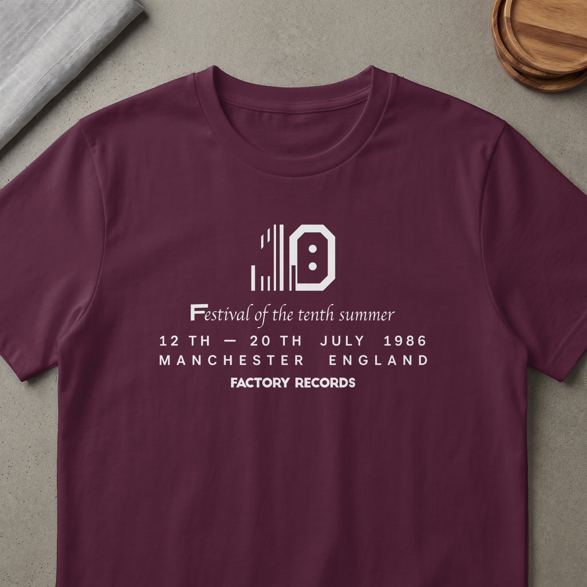 Maroon t-shirt with white text: Festival of the tenth summer, 12-20 July 1986, Manchester England, Factory Records.
