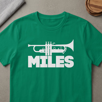Green t-shirt with white trumpet graphic and the word "MILES"