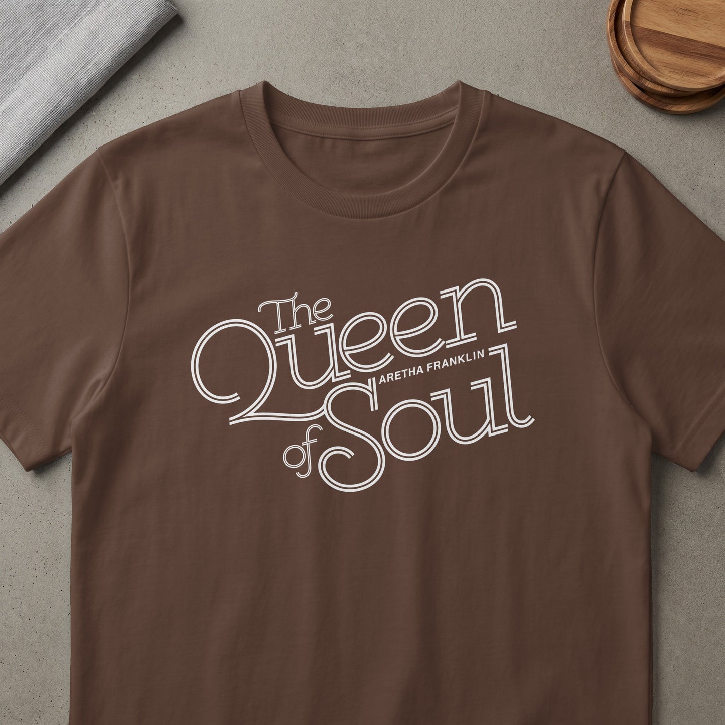 Brown t-shirt with white text "The Queen of Soul Aretha Franklin".