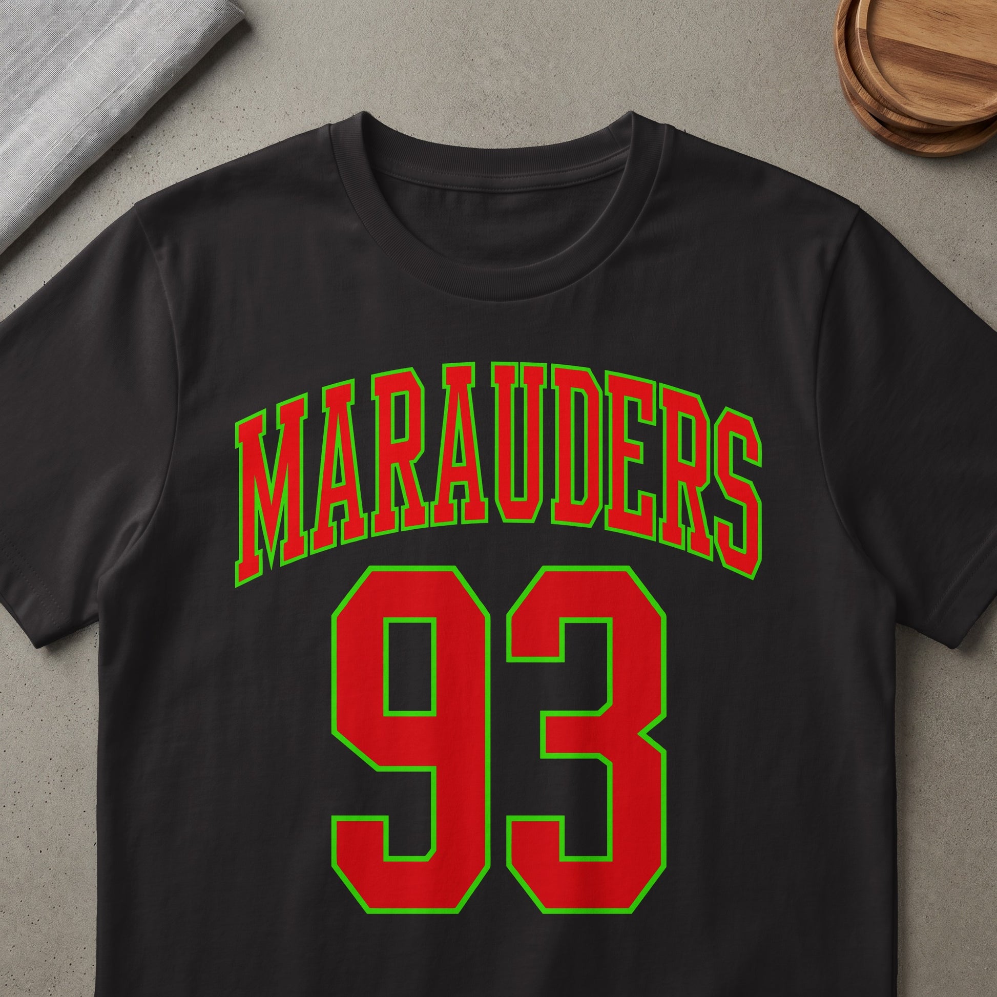 Black t-shirt with red and green "Marauders 93" text design.