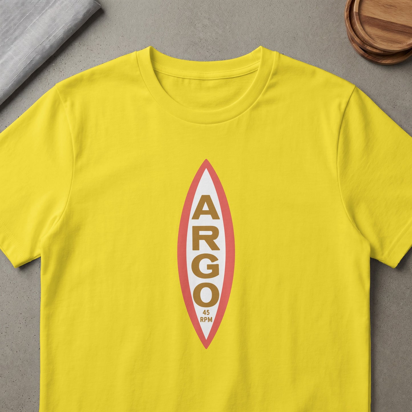 Yellow t-shirt with oval graphic with ARGO and 45 RPM text.