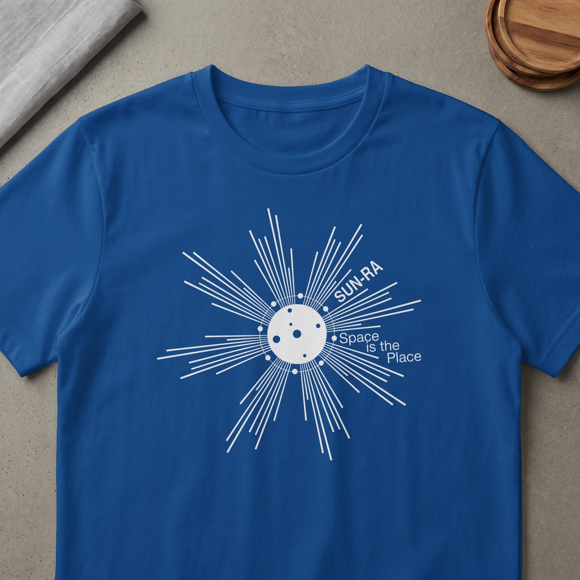 Blue t-shirt with white "Sun-Ra Space is the Place" graphic.