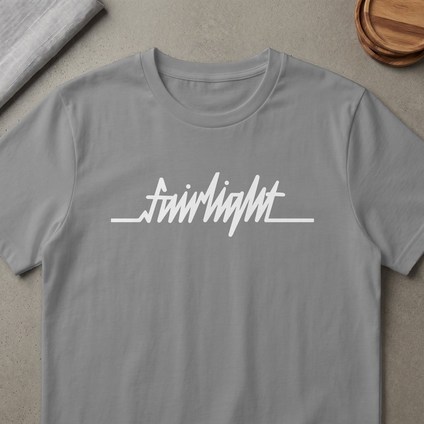 Grey t-shirt with white "fairlight" text and a heartbeat line.
