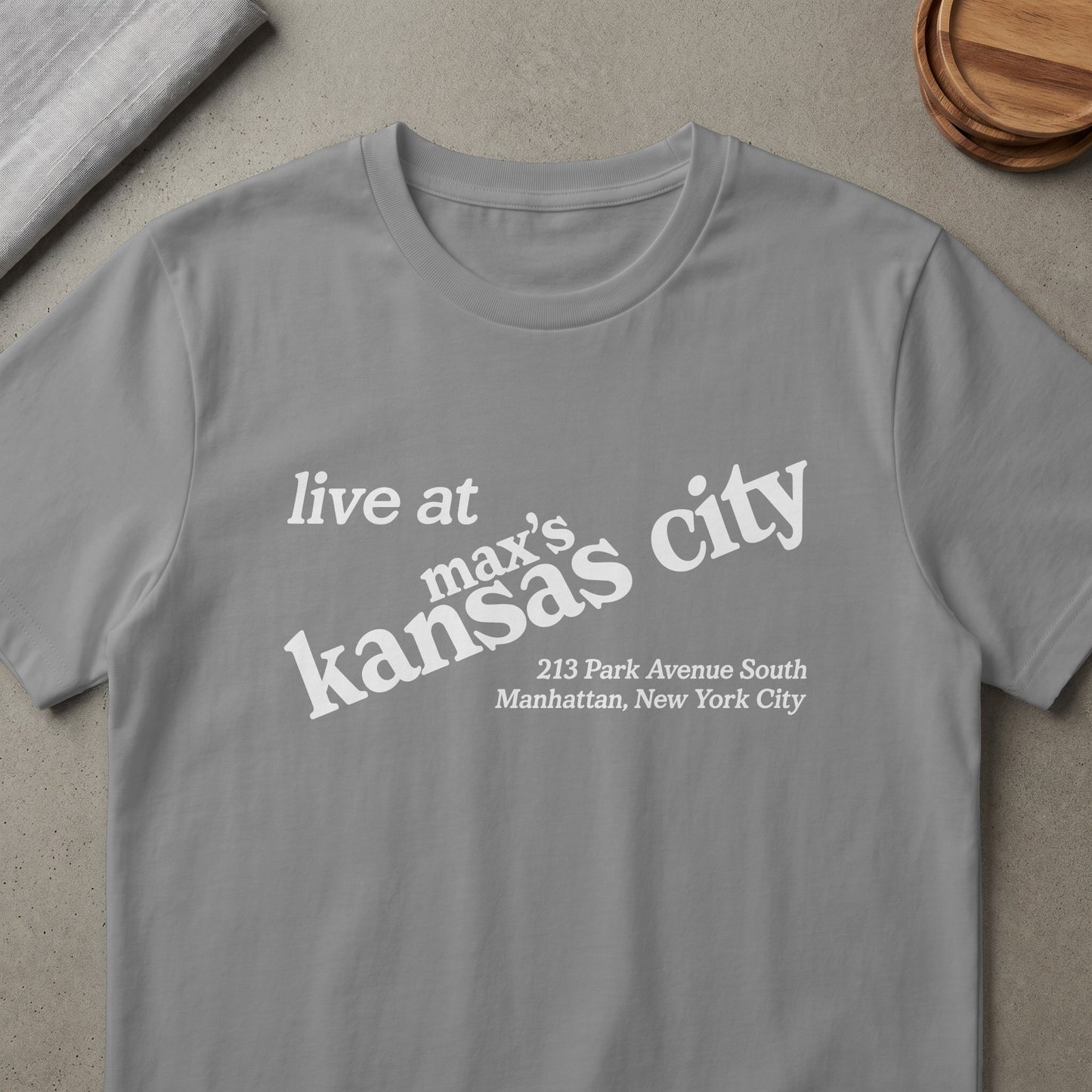 Grey t-shirt with white text: "live at max's kansas city 213 Park Avenue South Manhattan, New York City"