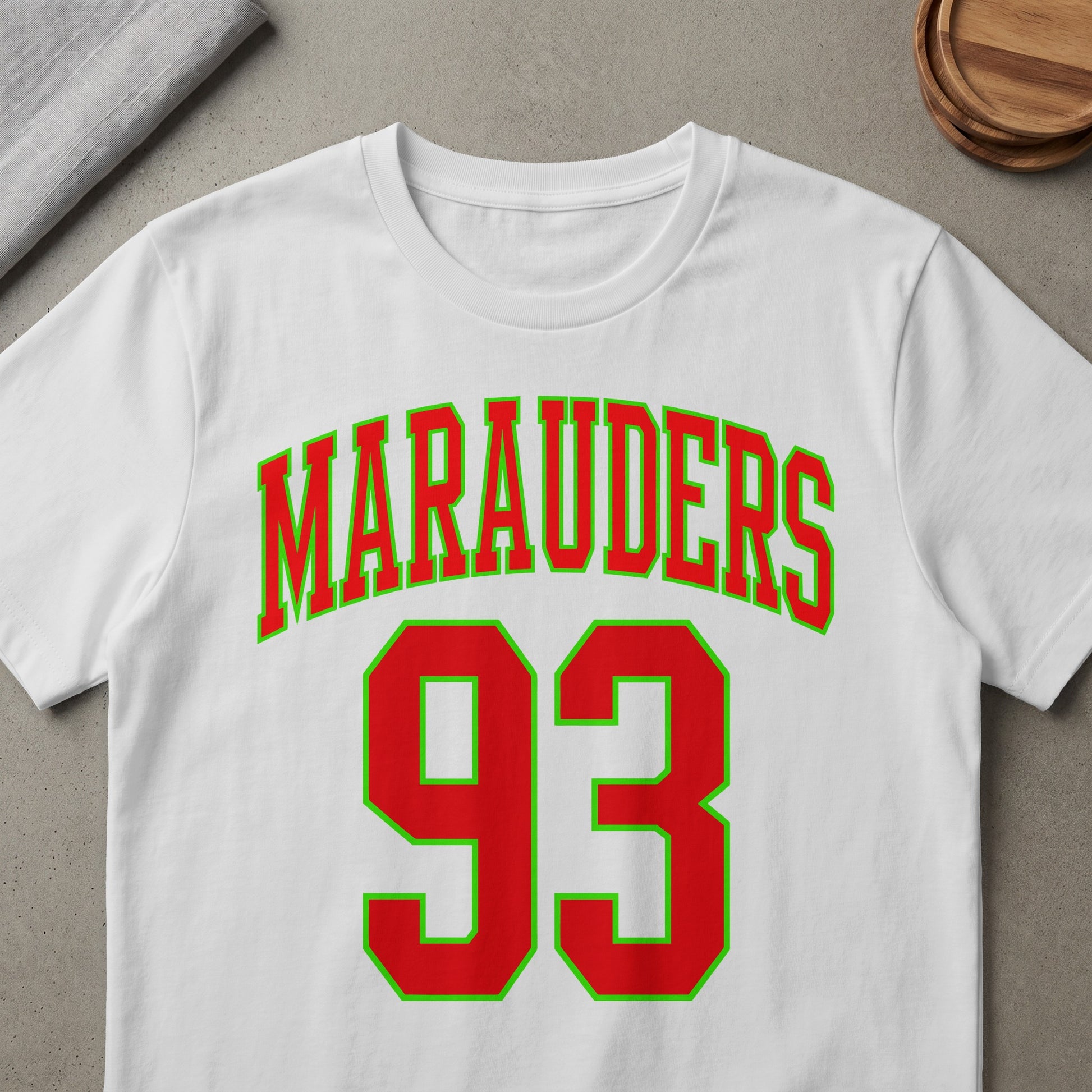 White t-shirt with red and green "Marauders 93" graphic.