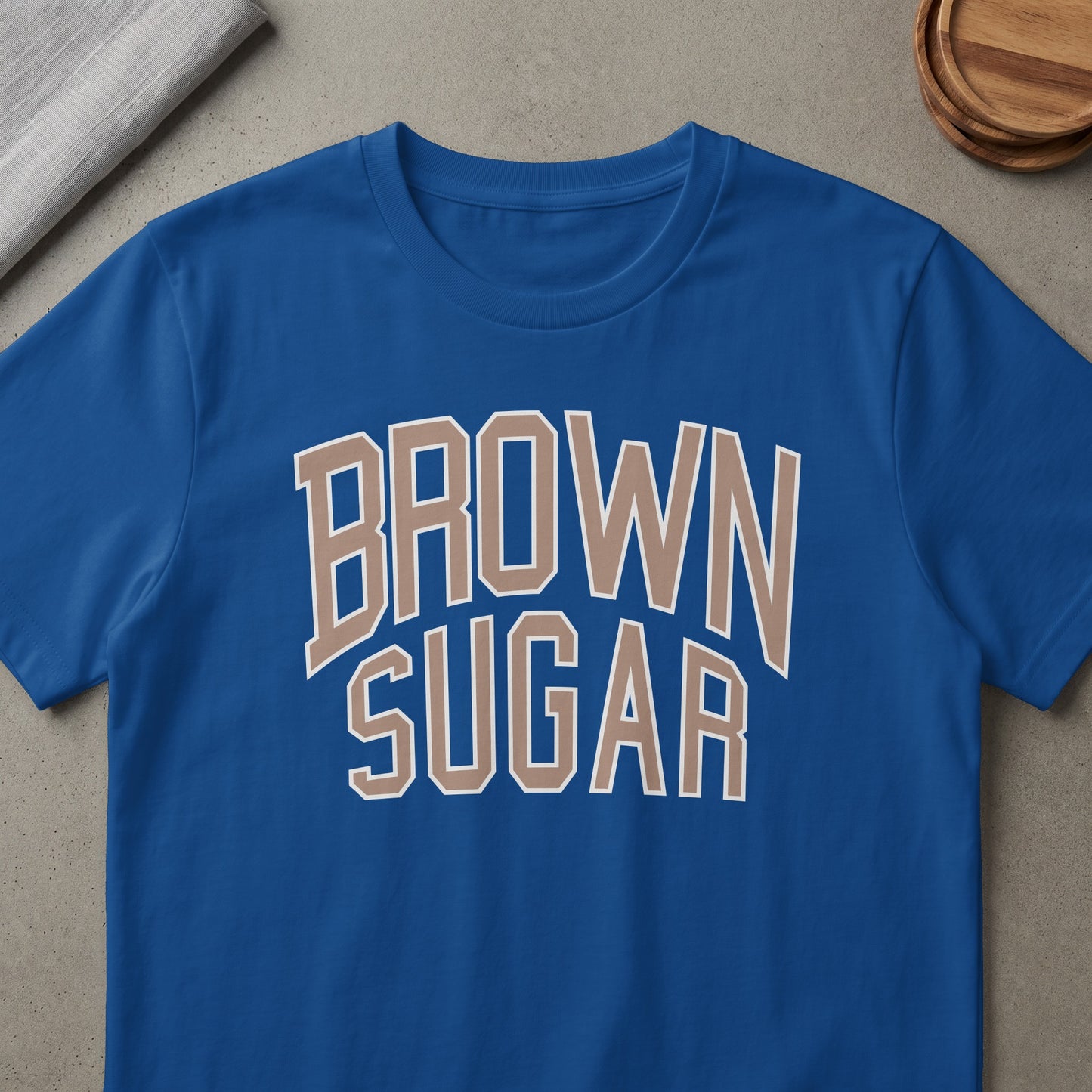 Blue t-shirt with "BROWN SUGAR" text in tan and white letters.