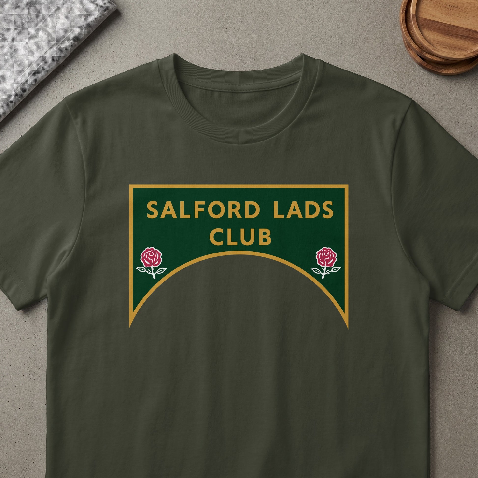 Dark green t-shirt with "SALFORD LADS CLUB" text and two red roses.