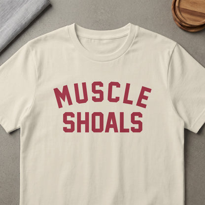 Cream t-shirt with "MUSCLE SHOALS" printed in maroon block letters.