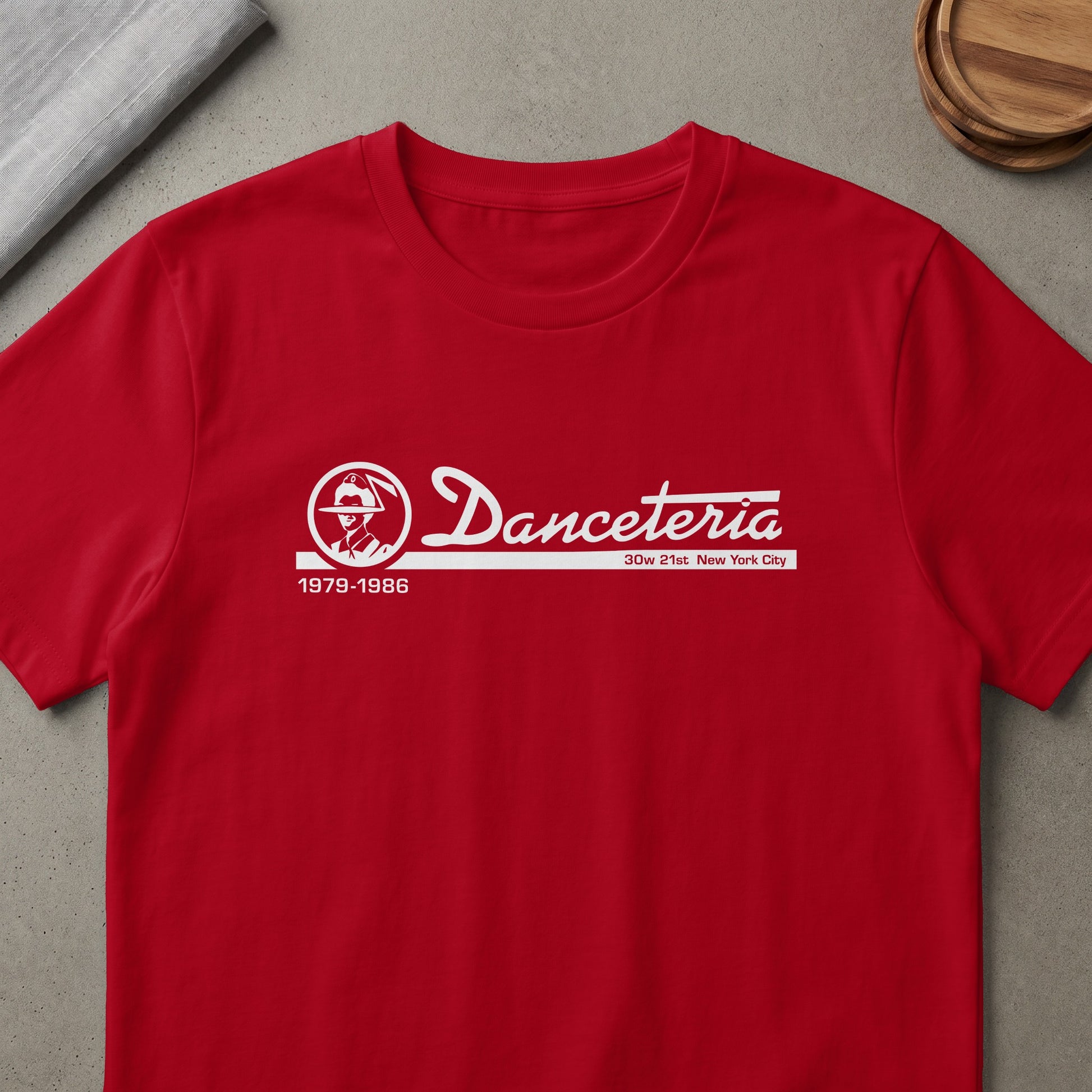 Red t-shirt with white "Danceteria 1979-1986 30w 21st New York City" text and logo.