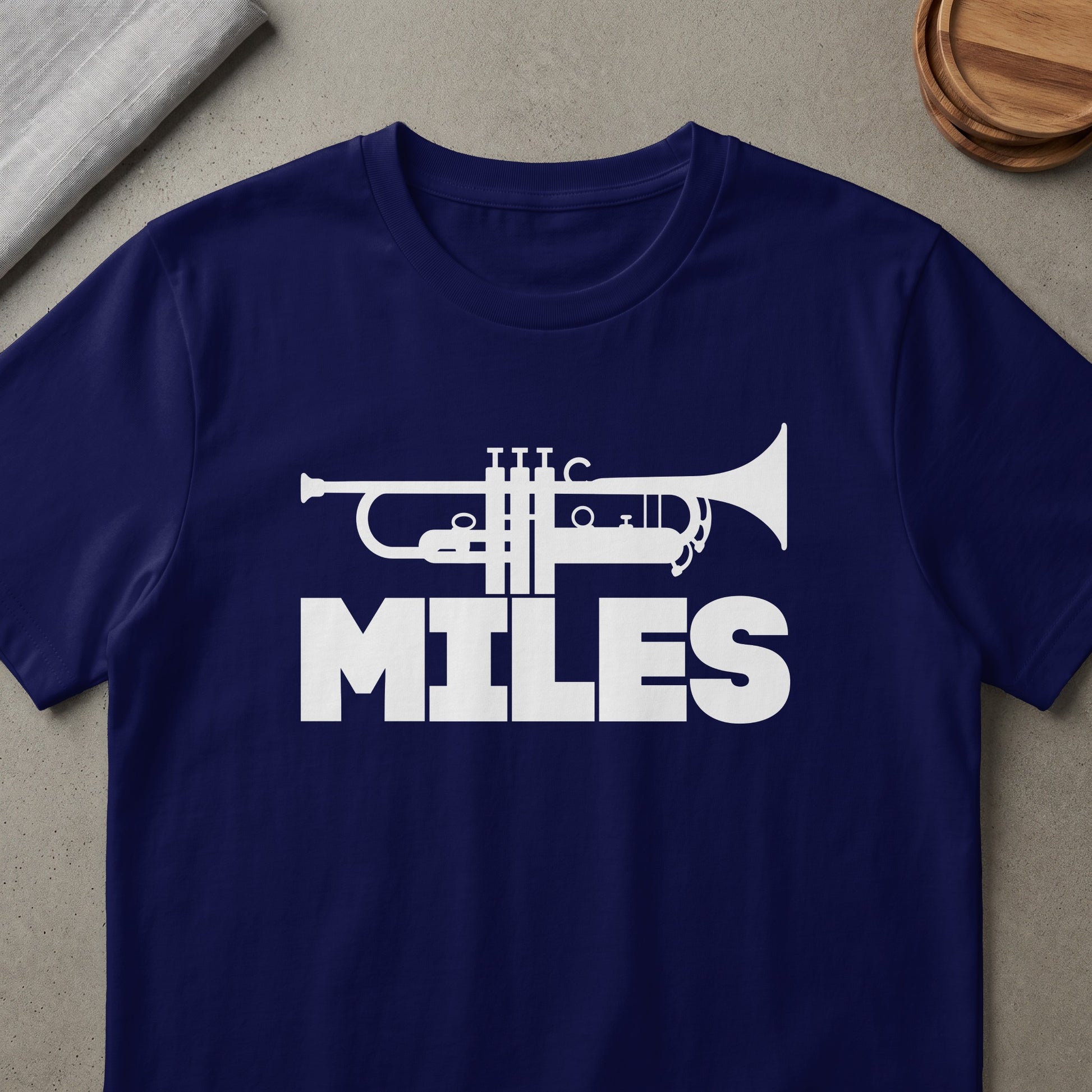 Navy t-shirt with white trumpet graphic and "MILES" text.