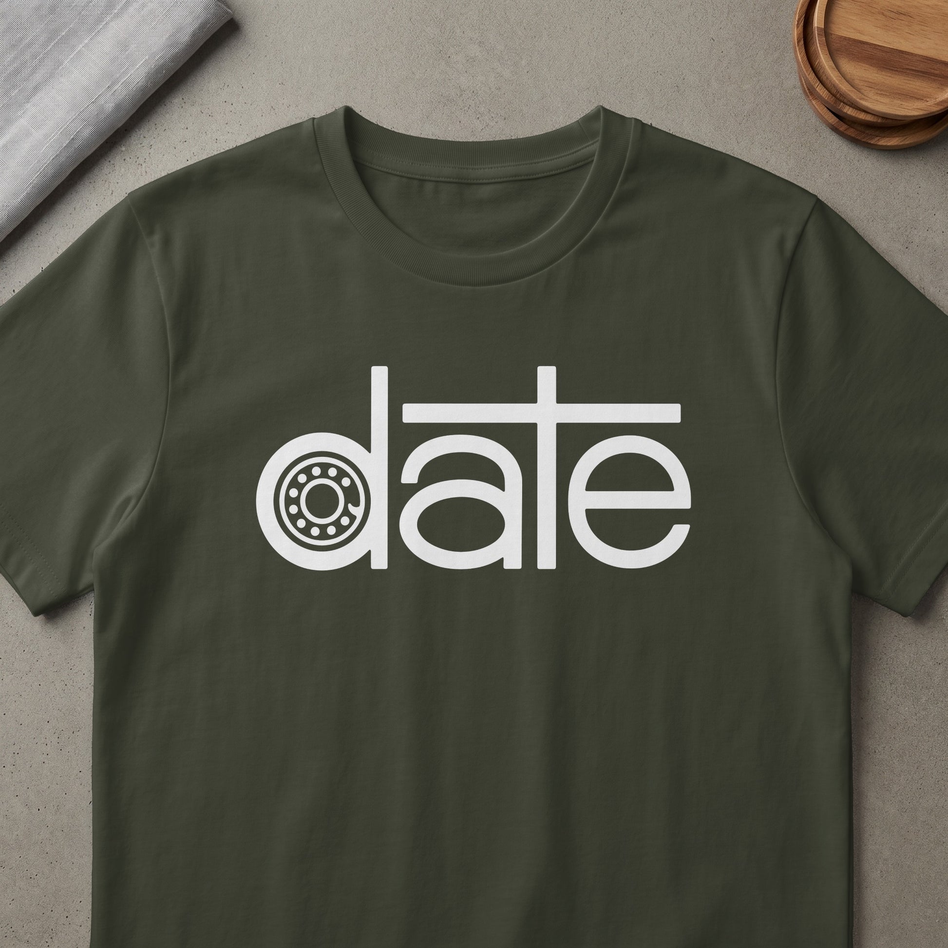 Dark olive t-shirt with white text that reads "date" with a bearing inside the "a".