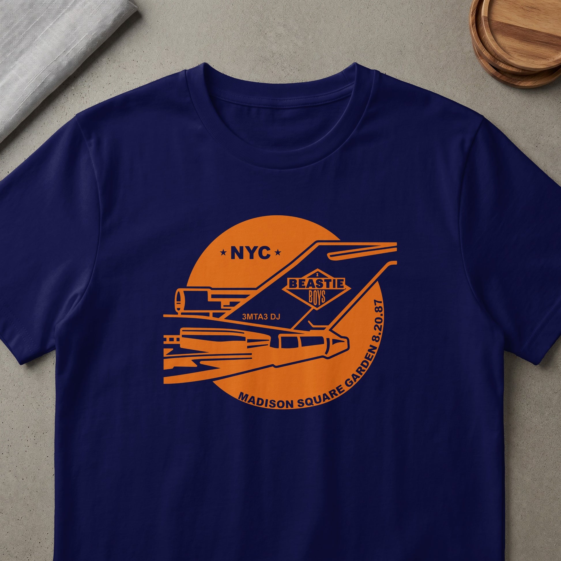 Navy t-shirt with orange Beastie Boys NYC Madison Square Garden 8.20.87 graphic.