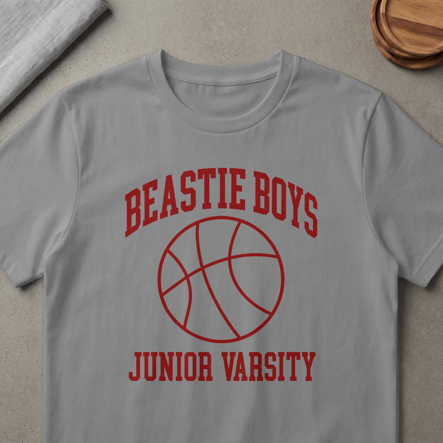 Gray t-shirt with red text "BEASTIE BOYS" above a basketball and "JUNIOR VARSITY" below.