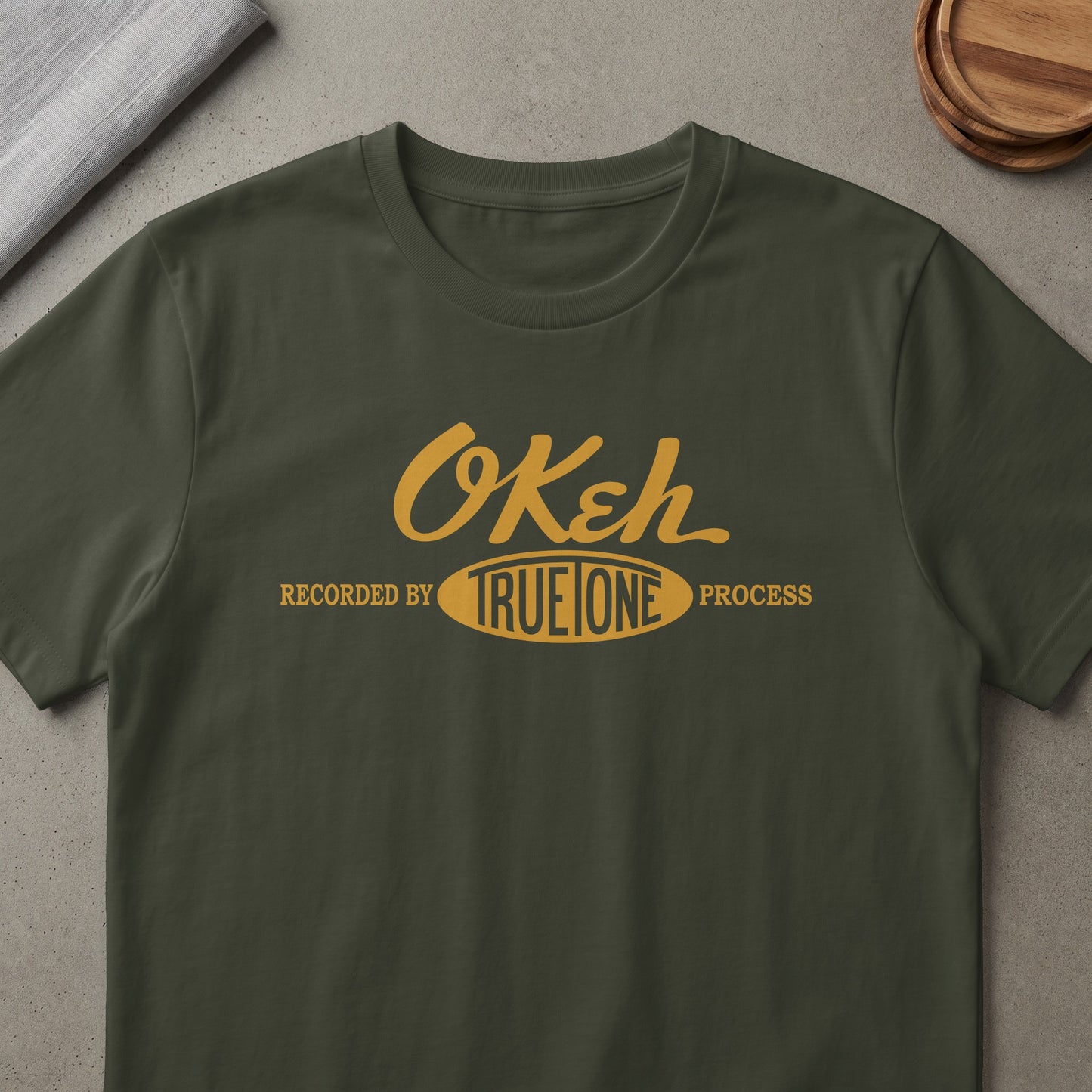 Green t-shirt with yellow text: "OKeh Recorded by TRUE ONE Process".