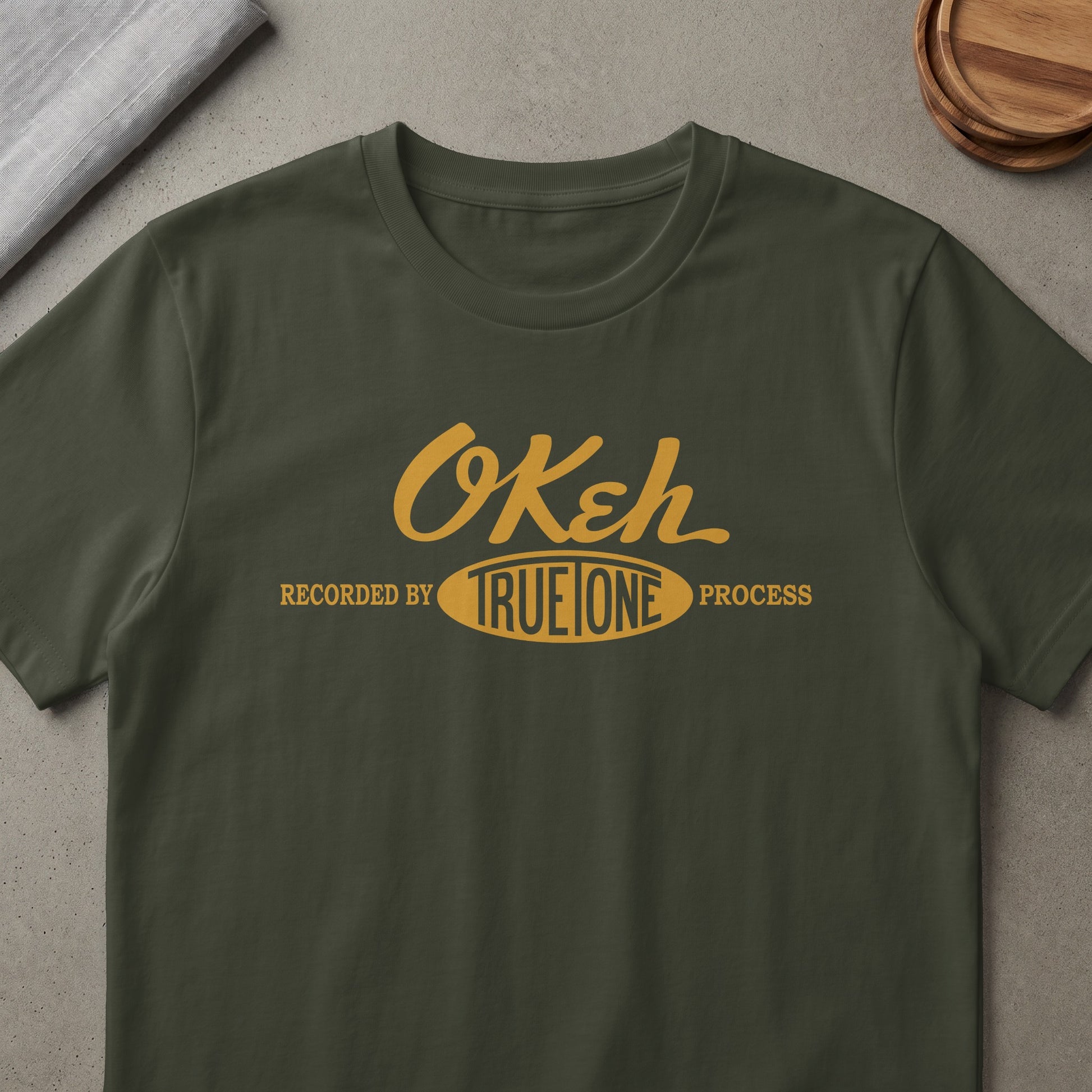 Green t-shirt with yellow text: "OKeh Recorded by TRUE ONE Process".