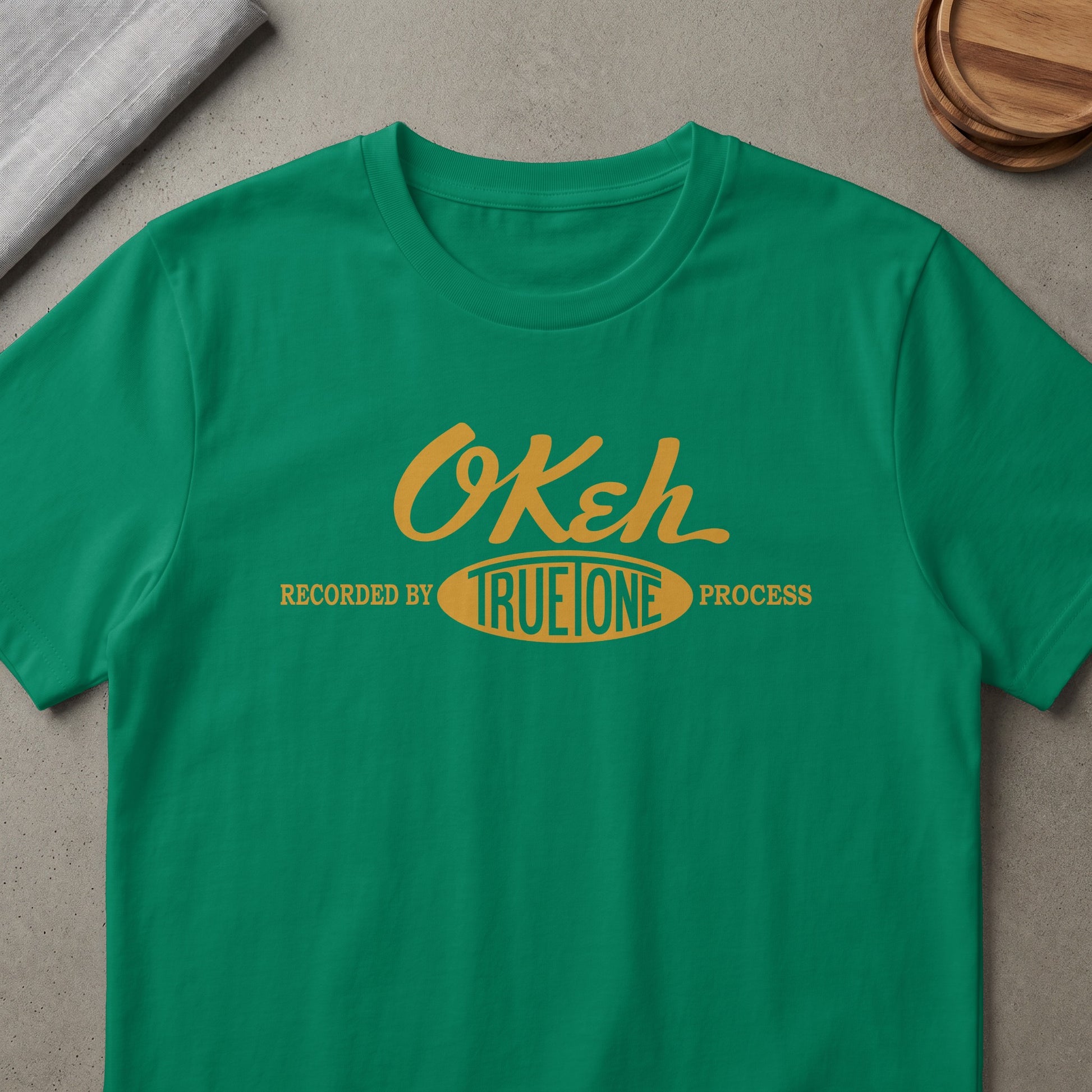 Green t-shirt with "Okeh Recorded by TrueTone Process" text.
