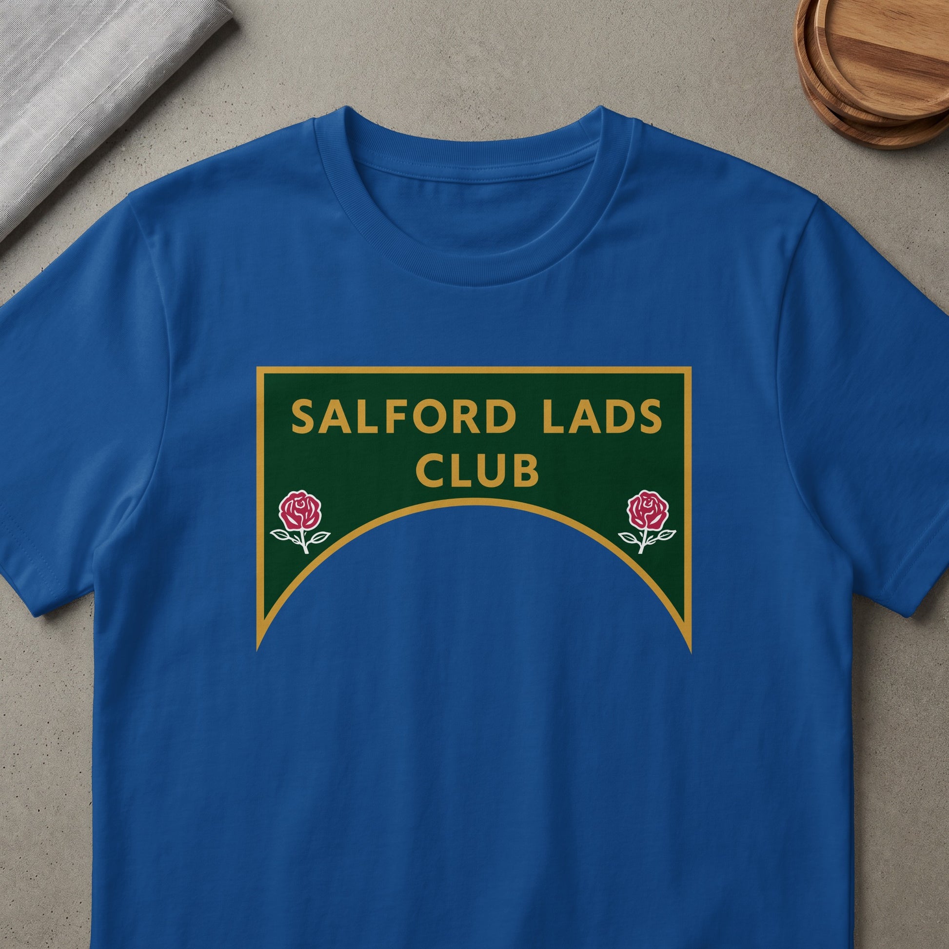 Blue t-shirt with Salford Lads Club logo featuring roses.
