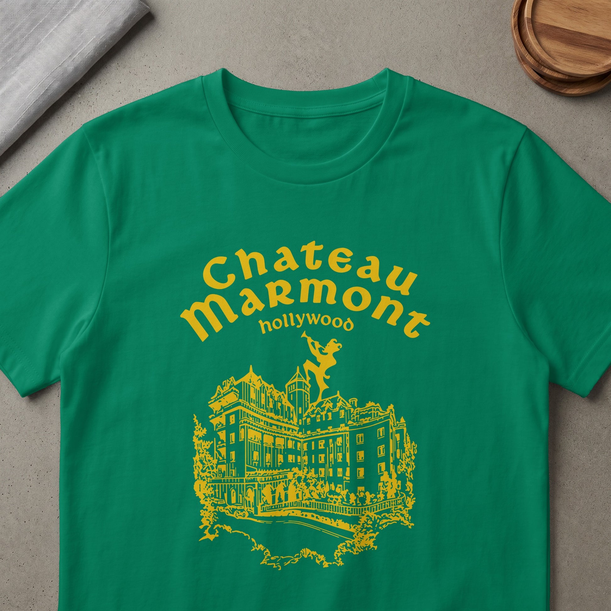 Green t-shirt with yellow Chateau Marmont Hollywood graphic and building illustration.