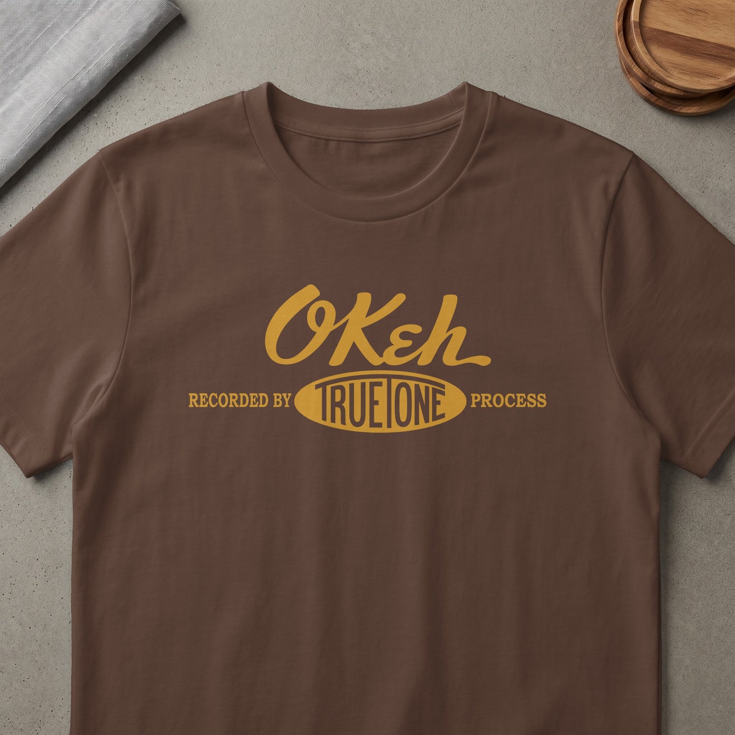 Brown t-shirt with yellow OKeh logo and "Recorded by True Tone Process" text.