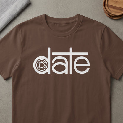 Brown t-shirt with white text "date" featuring a circular bearing graphic as the letter D.