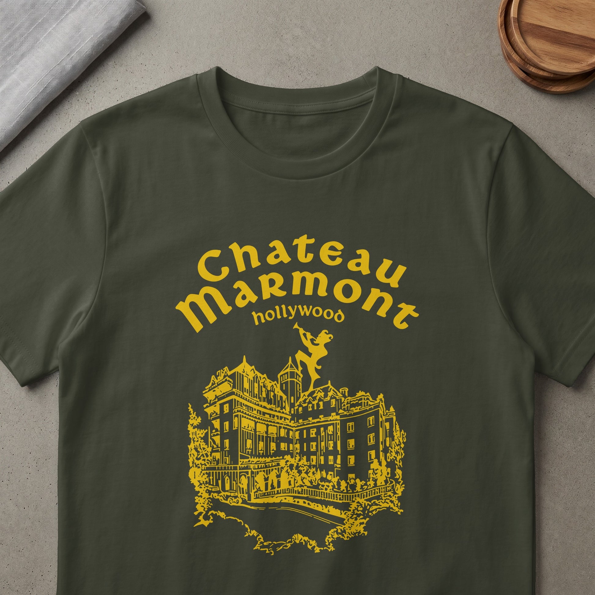 Chateau Marmont Hollywood graphic on a dark green t-shirt.